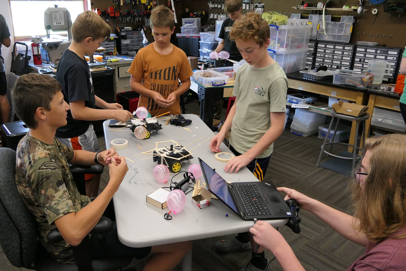 A group of Crusader Robotics campers building and testing battle bots at the summer STEM camp