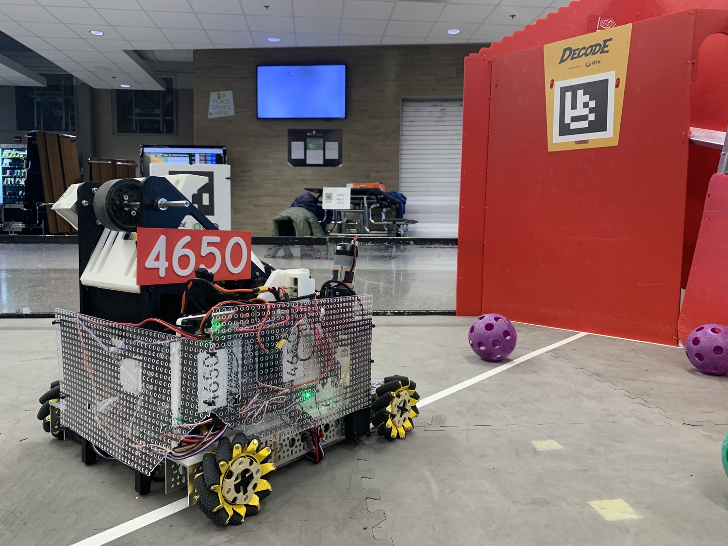 Team 4650's robot, labeled 4650, on the DECODE competition field — mecanum wheels, exposed wiring, and a Limelight camera